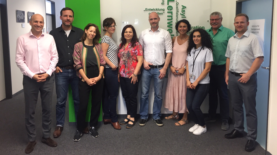 Mehrere Männer und Frauen stehen nebeneinander. (Quelle: © BAMF) Mehrere Männer und Frauen stehen nebeneinander.