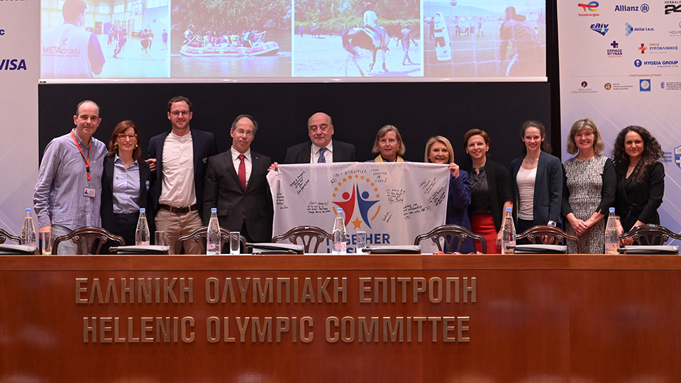 Frauen und Männer stehen vor einer Leinwand. (Quelle: METAdrasi) Frauen und Männer stehen vor einer Leinwand.